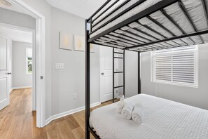 A bedroom with a bunk bed, a window with blinds, and a door leading to another room. - Beautiful 3-bedroom house pleasant Grove City (Grove City)