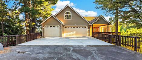 A two-story house with a garage, a covered porch, and a driveway.