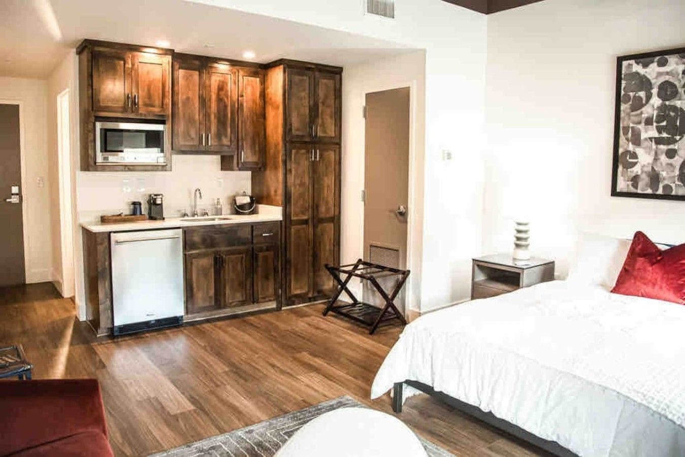 A compact bedroom with a bed, a small bedside table, and a nightstand.