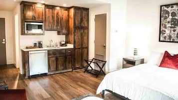 A compact bedroom with a bed, a small bedside table, and a nightstand.