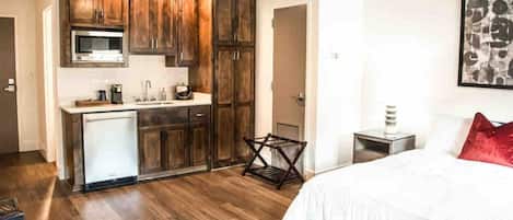A compact bedroom with a bed, a small bedside table, and a nightstand.