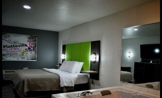 Premium Suite, 1 King Bed, Hot Tub | Desk, laptop workspace, blackout drapes, iron/ironing board