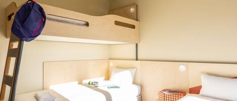 A bunk bed room with a ladder, a small table, and a nightstand.
