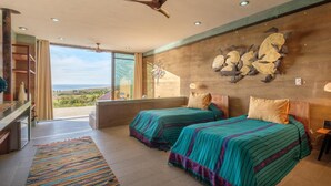 A bedroom with two beds, a large window, a ceiling fan, and a view of the outdoors. - Las Casitas (Todos Santos)