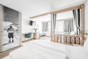 Ein modernes Hotelzimmer mit einem Bett, Schreibtisch und einem großen Gemälde.