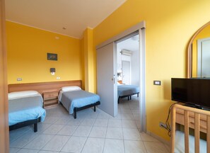 A hotel room with two beds, a television, and a bathroom visible through an open door. - Dei (Fano)