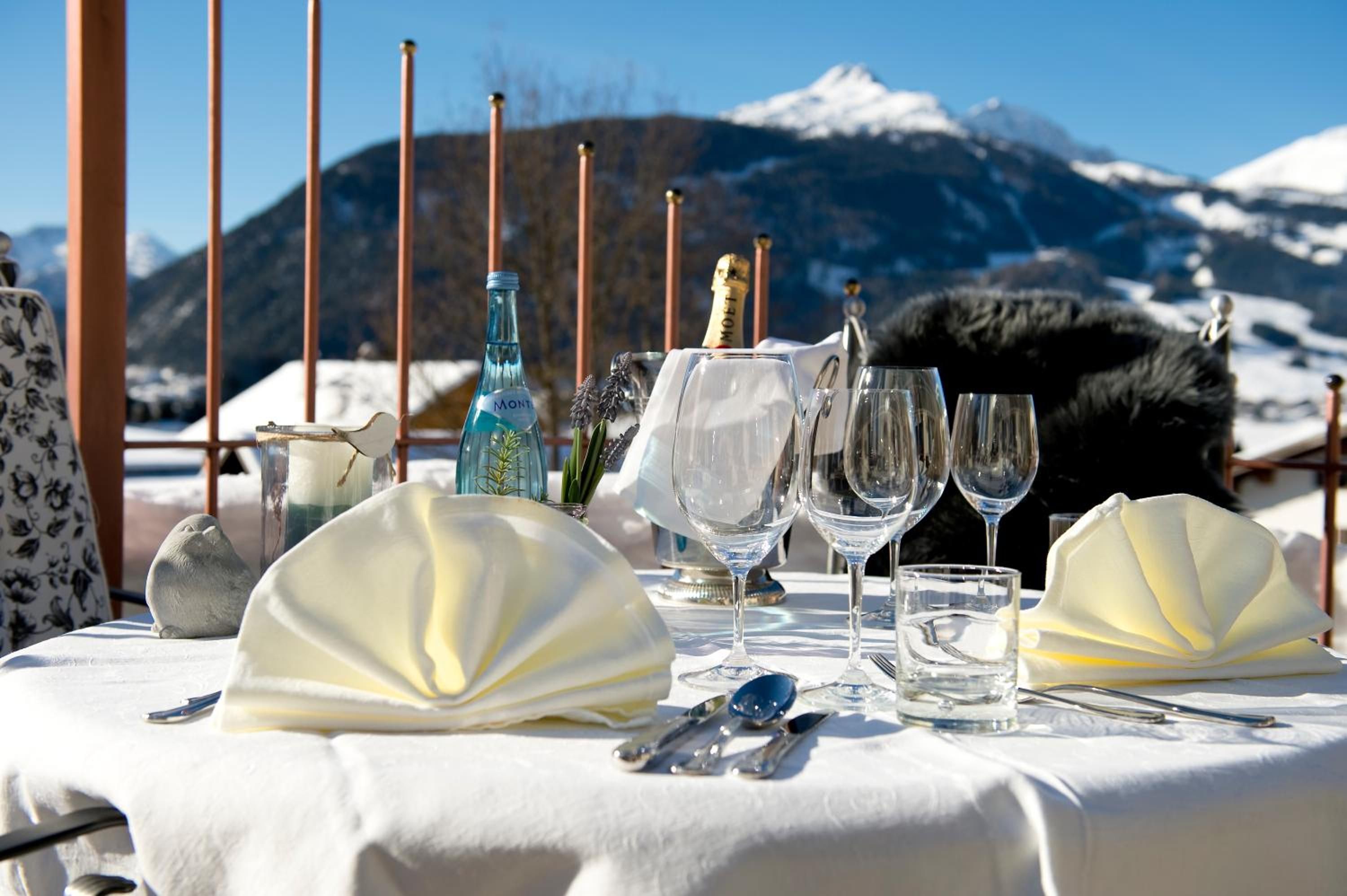 A table set for a meal with a mountain view in the background.