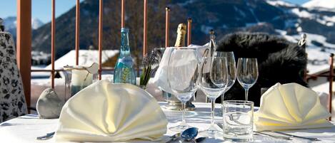 A table set for a meal with a mountain view in the background.
