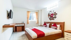 A bedroom with a bed, a desk, a chair, a television, and a window with curtains. - Münchner Löwenbräu (Cuxhaven)