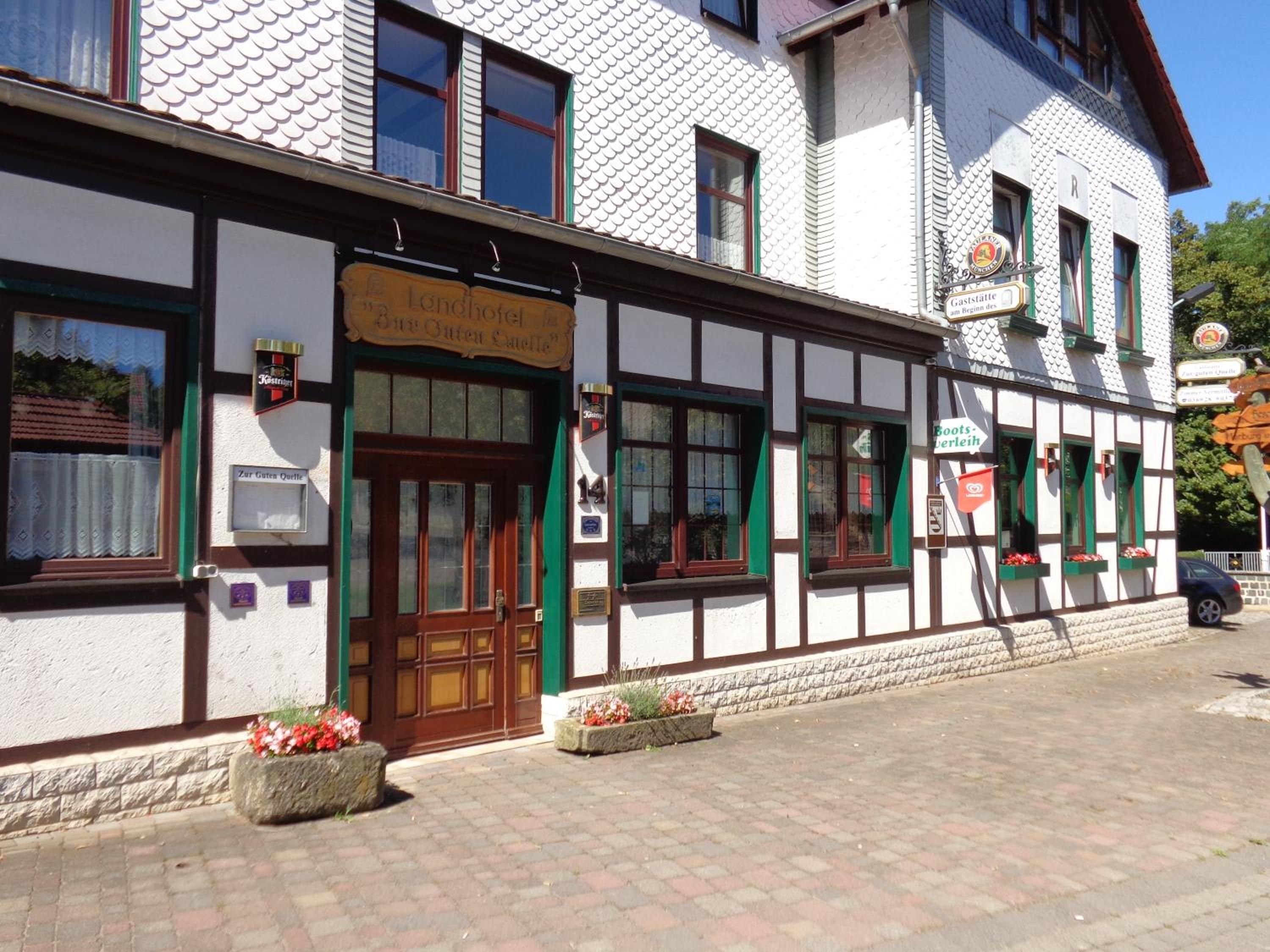 A traditional half-timbered building with a sign for a restaurant and a beer garden.