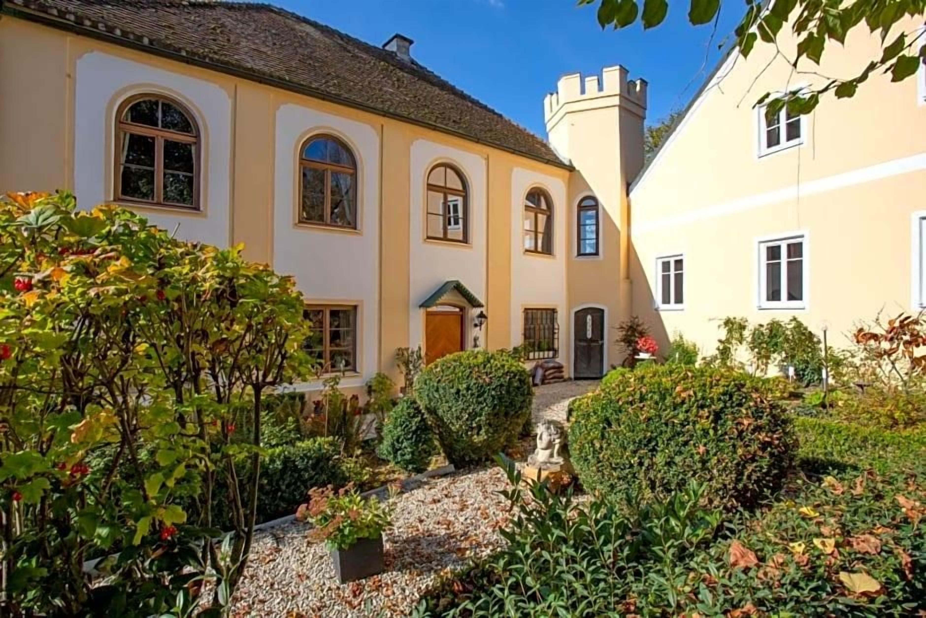 A traditional building with a symmetrical facade, arched windows, and a central entrance.