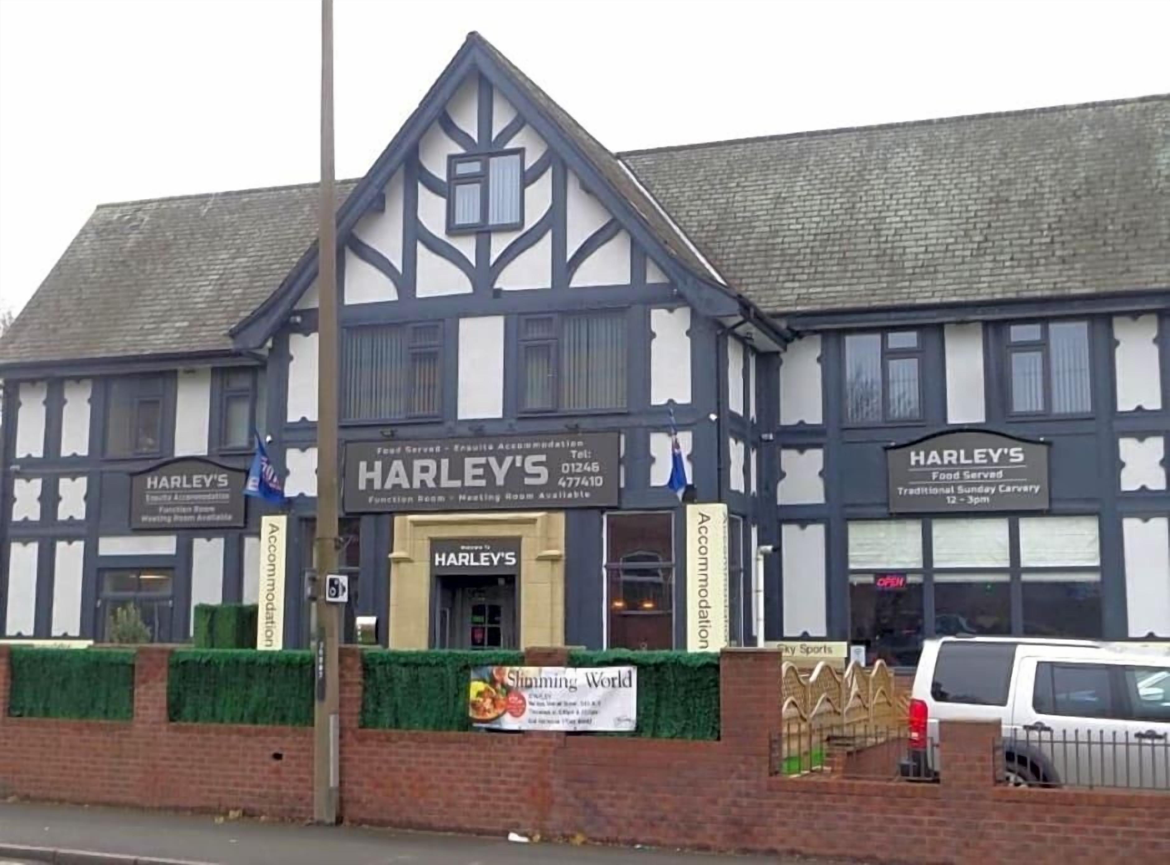 A traditional building with a sign for 'HARLEY'S' indicating food service.