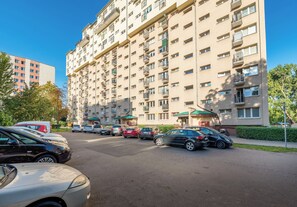 A multi-story residential building with a parking lot in front. - Mokotów Rzymowskiego Urban Apartment (Warszawa)