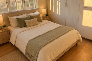 A bedroom with a bed, bedside tables, a lamp, a plant, and a wardrobe. - Luxury Cottage Escape Sleeps 4 with Hot Tub & Pool (Keston)