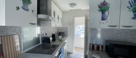 A modern kitchen with a built-in oven, a microwave, and a toaster.