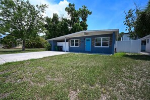 A single-story house with a garage, a front door, and a small front yard. - The Grounded Oak | 1mi to UT, Fenced Yard (Tampa)