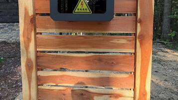 A wooden structure with a warning sign for electrical danger.