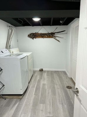 A laundry room with a washing machine, a drying rack, and a vent. - The Liberty House / 3 BR • 2 BA / SPIRE • Wineries • Lake Erie (Geneva)