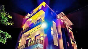A multi-story building with balconies and external lighting. - Asapian House by Shrigo Hotels (Moradabad)