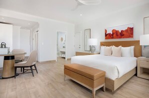 Une chambre d’hôtel avec un lit, des tables de chevet, un bureau et une chaise.