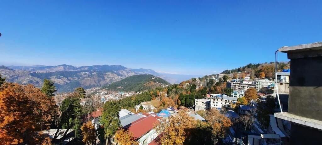A mountainous landscape with buildings and trees.