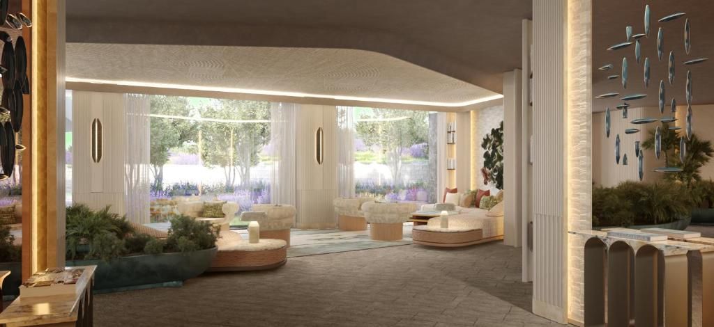 Een ruime lobby met een zithoek, grote ramen en een modern design.