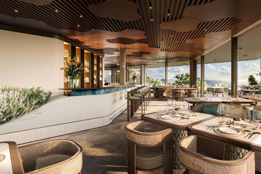 A restaurant with outdoor seating, a bar area, and large windows offering a view.