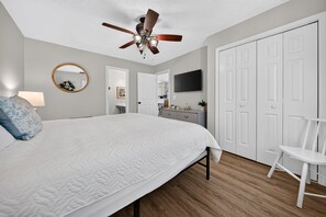 A bedroom with a bed, a ceiling fan, a television, a wardrobe, and a chair. - Palmetto Paradise, Pet Dogs ONLY 20lbs max Pool, Golf & Fairway Views (Pawleys Island)