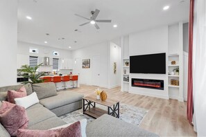 Ein modernes Wohnzimmer mit einer Couch, einem Couchtisch und einem Kamin.