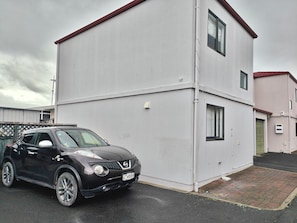 A two-story building with a car parked in front. - Fresh, Cosy & Handy to CBD, Lake, Waikato Hospital, Gym (2) and Dinsdale Shops (Hamilton)