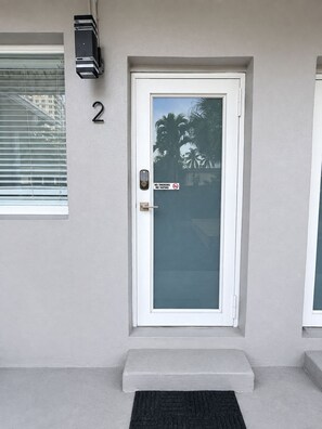 A door with a 'No Smoking' sign, a mailbox, and a number '2' on the wall. - Modern Studio with Pool near Miami Beach (Miami)