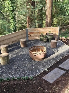 A raised garden bed with potted plants and a central decorative bowl. - Belle Cottage (Montrose)