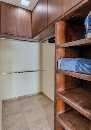 A storage closet with wooden shelves, a metal rod, and a tiled floor. - Casa Cactus with a heated pool for 7 people in Centenario. (El Centenario)