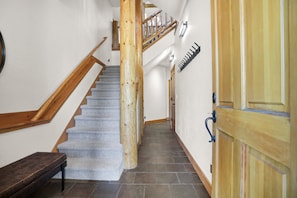 A staircase with wooden handrails and carpeted steps leading to a landing. - New Listing - Custom Furnishings - Ski Season Shuttle - Community Pool & Hot Tub (Steamboat Springs)