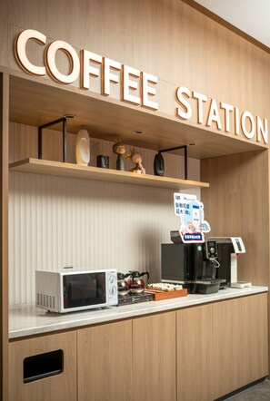 A coffee station with a sign, a microwave, a coffee machine, and some decorative items. - Holiday Inn Express Shanghai North Bund Riverside (Shanghai)