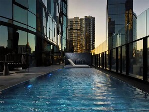 An indoor swimming pool with a view of high-rise buildings in the background. - Cosy 2BR apartment close to Melbourne Exhibition Centre and Crown (Southbank)