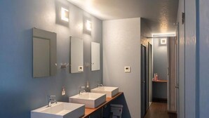 A modern bathroom with three sinks, mirrors, and a wooden vanity. - Dragon Inn Nikko (nikko)