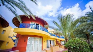 A multi-story hotel with balconies, palm trees, and a clear sky. - Carols Beau Rivage Matrouh (Marsa Matrouh)