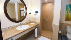 A bathroom with a large mirror, a sink, a shower, and a toilet. - Carols Beau Rivage Matrouh (Marsa Matrouh)