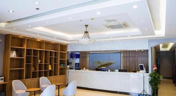A reception area with a desk, chairs, and a large wooden shelving unit. - Greentree Inn Beijing Qinghe High-speed Railway Station Shangdi Anningzhuang Shell Hotel (Beijing)