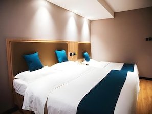 A hotel room with a large bed, two pillows, a bedside table, and a wall-mounted lamp. - Greentree Inn Beijing Qinghe High-speed Railway Station Shangdi Anningzhuang Shell Hotel (Beijing)