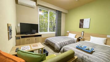 Ein Hotelzimmer mit zwei Betten, einem Fernseher, einem kleinen Tisch mit einer Speisekarte und einem Fenster mit Blick auf Bäume.