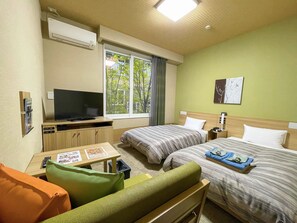 A hotel room with two beds, a TV, a small table with a menu, and a window with a view of trees. - Route-inn Grantia Wakamiya (Miyawaka)