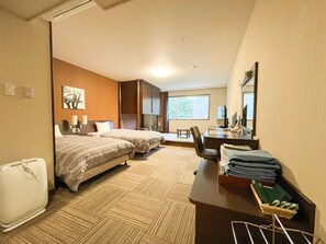 A hotel room with two beds, a desk with a computer, a chair, a mirror, and a window with a view. - Route-inn Grantia Wakamiya (Miyawaka)