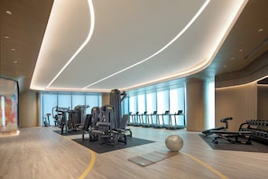 A modern gym with cardio equipment, weight machines, and a large exercise ball. - Crowne Plaza Chaozhou Riverside (Chaozhou)