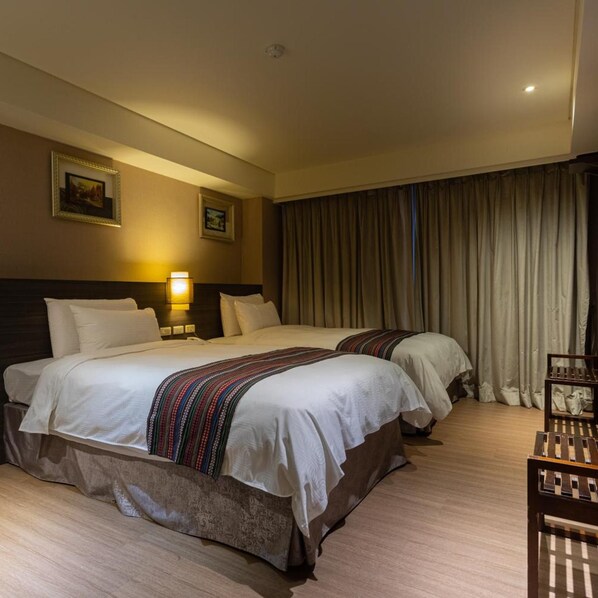 A hotel room with two beds, a nightstand with a lamp, a wooden chair, and a large window with curtains. - Royal Guest Hotel (Tainan)