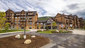 A multi-story hotel with a modern architectural design, featuring balconies and large windows.