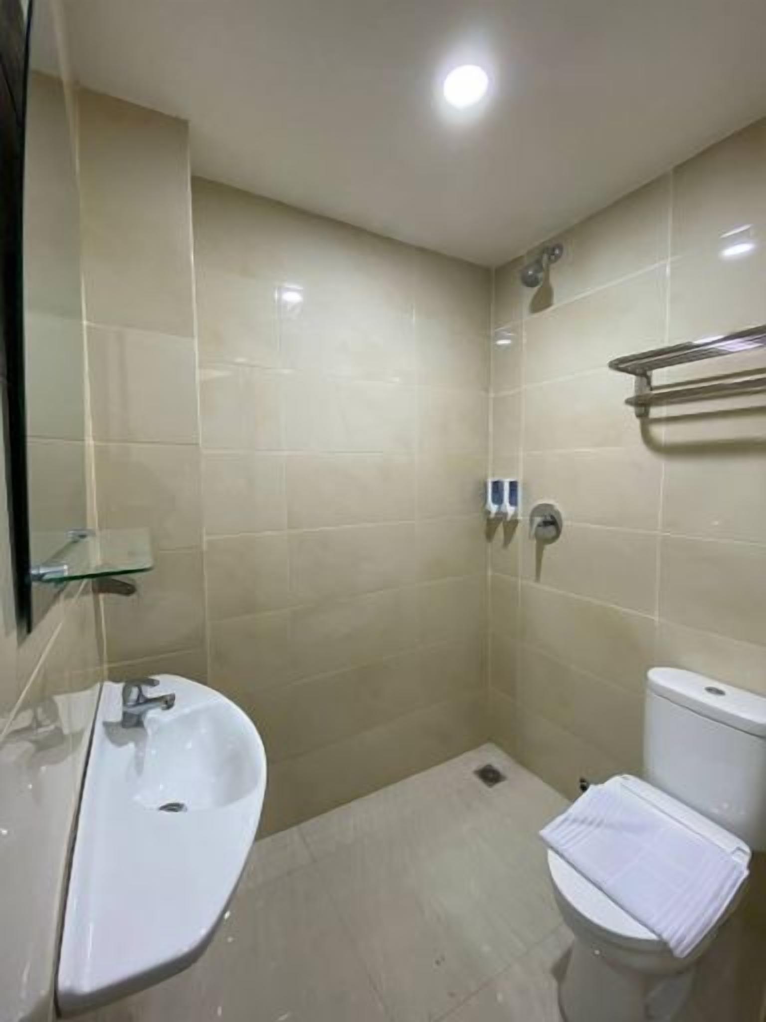 A bathroom with a sink, toilet, and shower.
