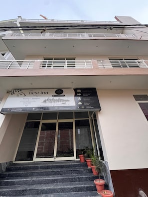 Entrada de hotel con un letrero que anuncia habitaciones, un salón de banquetes y un spa.