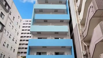 A multi-story building with a blue facade and a ground-level entrance.